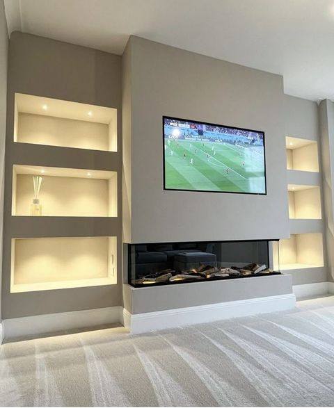 Media wall with inset electric fire and integrated shelving in Ormskirk